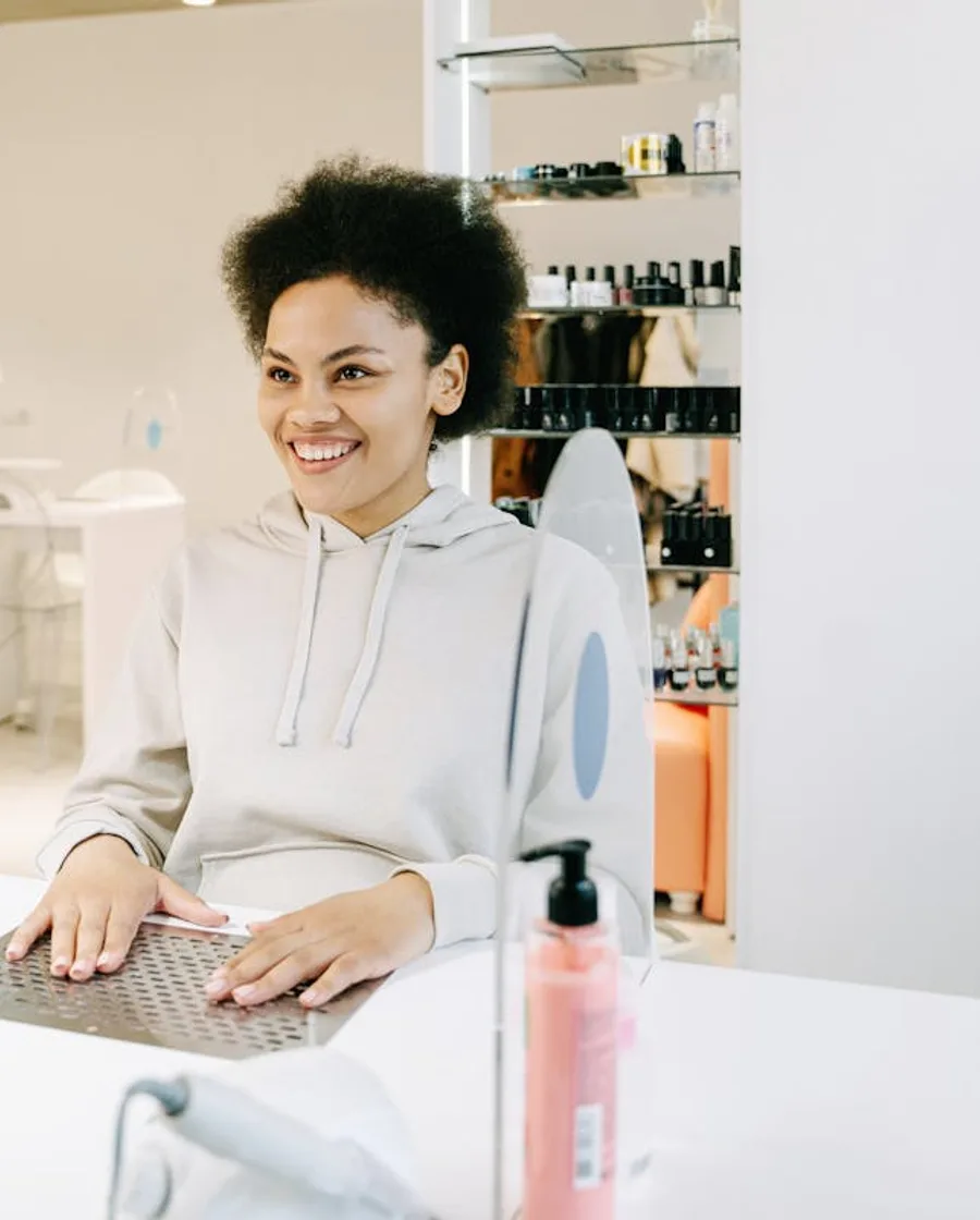 Client smiling during a nail appointment